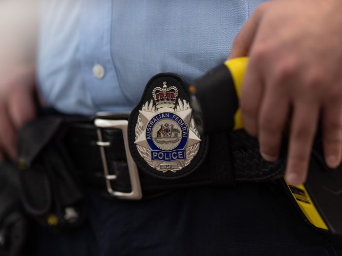 Close up of an AFP officer's waste strap focussing on the AFP badge