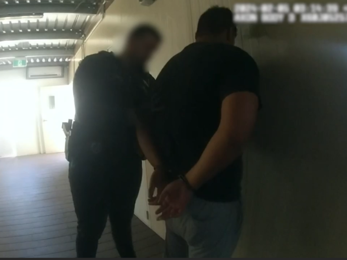 Officer arresting man