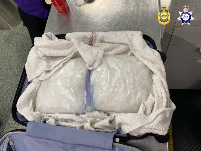 A picture of suspected methamphetamine wrapped in a towel within a suitcase 