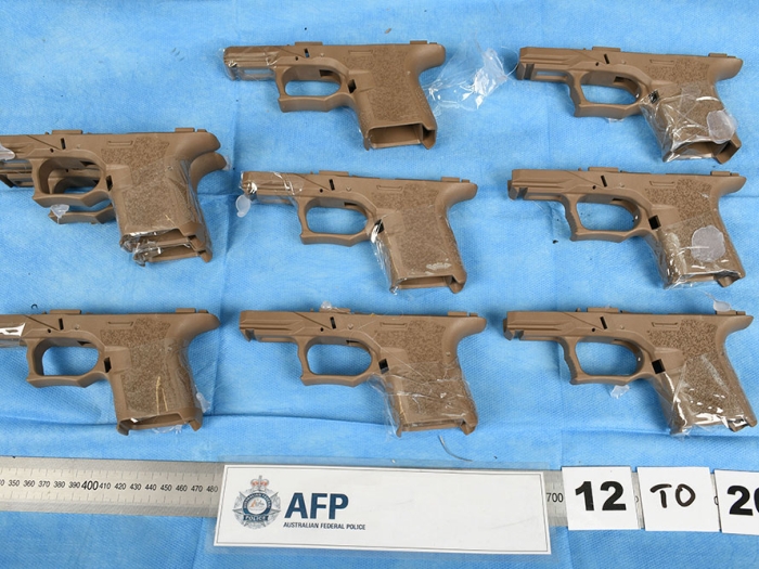 Three men have been charged for their alleged roles in attempts to import a large number of firearms parts into Australia through the postal system.