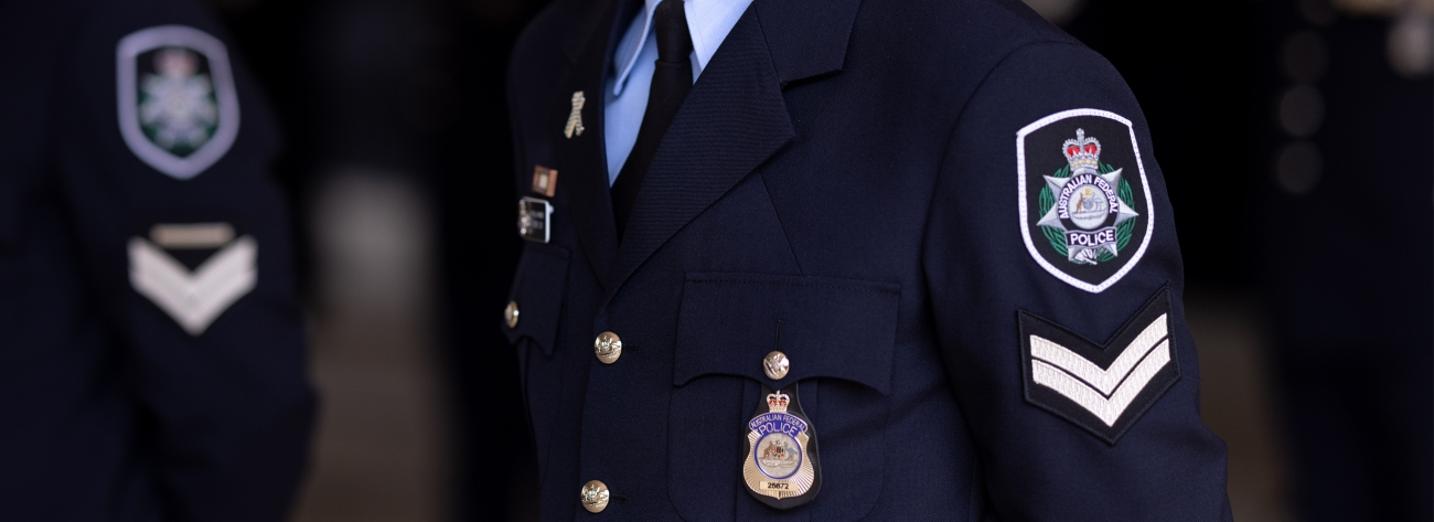 The AFP ceremonial badge on a navy jacket