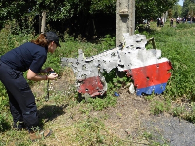 Investigator photographing a piece of the wreckage from MH17